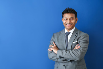 Handsome businessman on color background