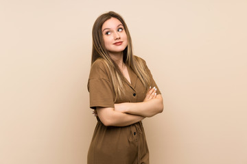 Teenager girl over isolated background making doubts gesture while lifting the shoulders