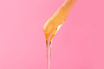 Fototapeten Stick with sugaring paste on color background © Pixel-Shot