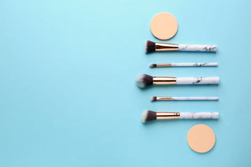 Set of brushes and sponges for contouring makeup on color background