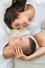 Fototapeta na wymiar Adorable loving couple lying in bed