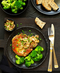 Fried pork steak with broccoli and onion sauce.