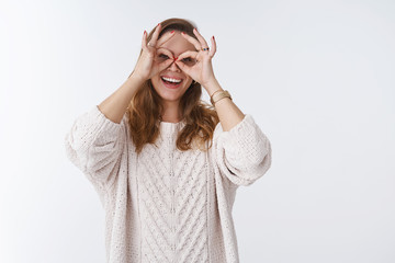 Charming playful charismatic young carefree woman having fun fool around showing goggles making finger glasses on eyes smiling broadly playing expressing positivity, opimistim wellbeing