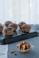 Homemade muffins with powdered sugar and fresh berries