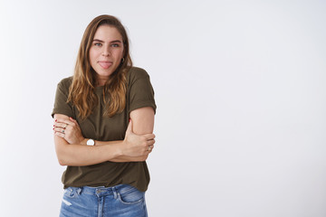 Carefree charming young happy girlfriend fool around showing tongue trembling standing chilly windy...