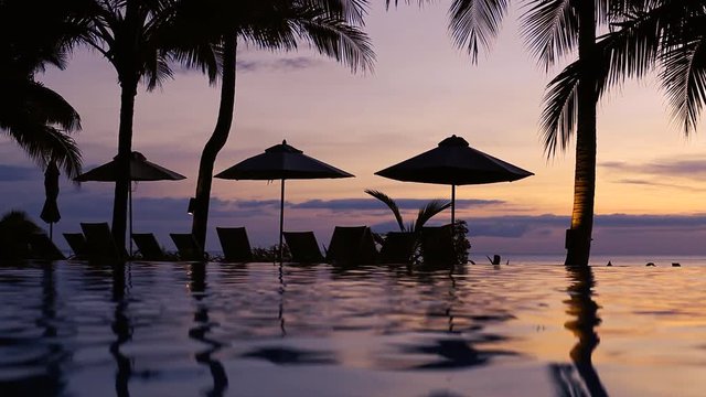 luxury beach villa hotel with swimming pool in the evening, luxurious quiet spa resort after sunset by night