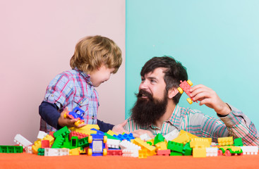 creative idea. small boy with dad playing. happy family creative leisure. building home with constructor. child development. father and son play creative game. Spending quality time with family