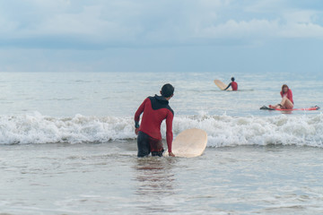 active people with surf board enjoy watersport 