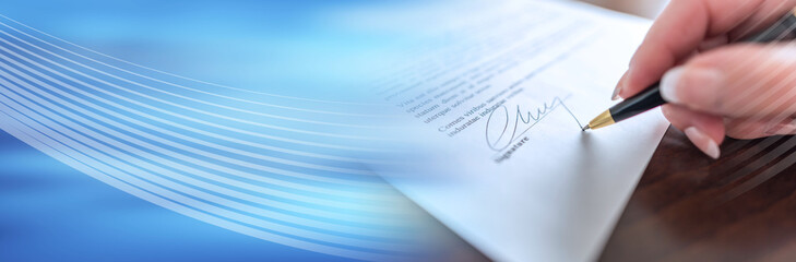 Hand signing a contract. panoramic banner