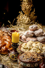Bowl with kutia - traditional Christmas sweet meal in Ukraine, Belarus and Poland, on wooden table, Christmas Family Dinner Table Concep.