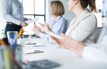 business, corporate and success concept - colleagues applauding to businessman at office meeting or presentation