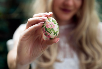 Woman holding Easter egg close up