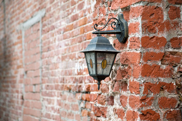 vintage lantern on a red brick wall close up