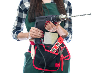 Beautiful woman in coverall holding drill machine isolated on white