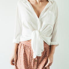 Young pretty woman in long skirt, white blouse on white background. Fashion trendy stylish clothes...