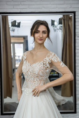 Portrait of young bride in wedding dress in salon