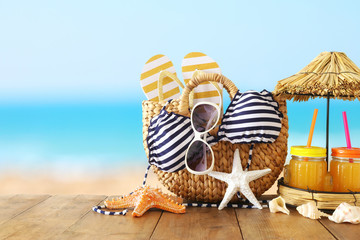 vacation and summer concept with sea life style objects and fresh fruit drink over wooden table