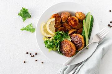 Dinner plate with healthy food. Fresh beef cutlets with new potatoes and salad on white background top view
