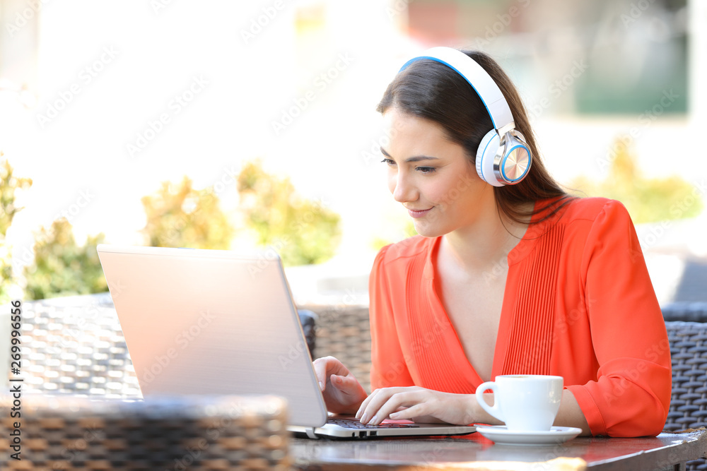 Sticker Woman with headphones using a laptop in a coffee shop