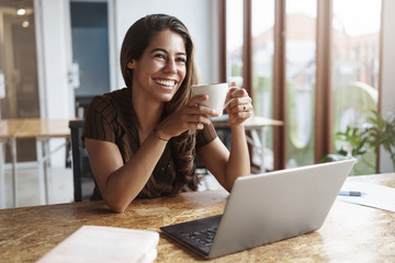 Work goes fast good team around. Charming carefree businesswoman hold coffee mug laughing looking...