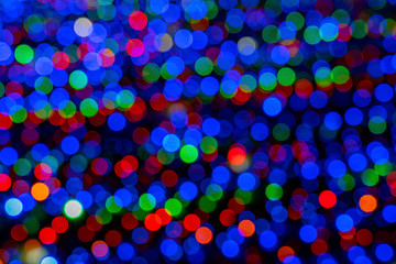 Blurry multicolored garland with glowing lights. Christmas, new year, birthday and wedding concept