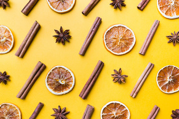 Fototapeta na wymiar Spices or Mulled wine ingredients on yellow background. Top view, flat lay. Copy space for your text.