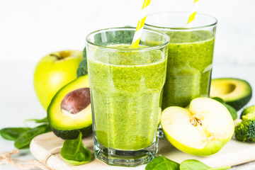 Green smoothie from fruit and vegetable on white.