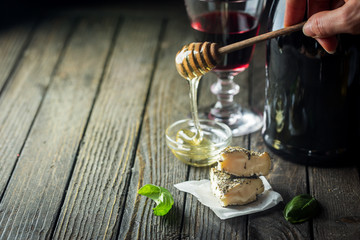 Soft goat cheese with herbs on the old dark wooden table