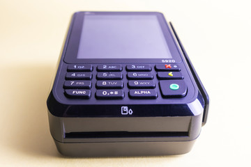 Pos terminal on a light background. Banking equipment. Acquiring. Acceptance of bank credit cards. Contactless payment.