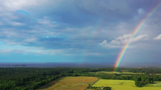 Aerial drone panning past rainbow
