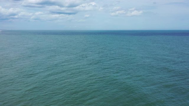 Aerial of drone flying over the ocean