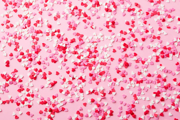 Fototapeta na wymiar Sugar hearts on pink background. Romantic, St Valentines day concept. Top view.