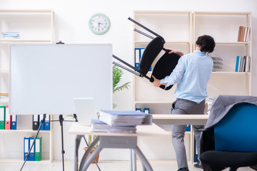 Young male employee unhappy with excessive work 