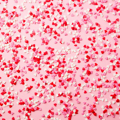 Sugar hearts on pink background. Romantic, St Valentines day concept. Top view.