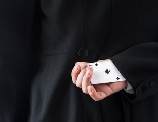 Businessman with ace card hidden under sleeve