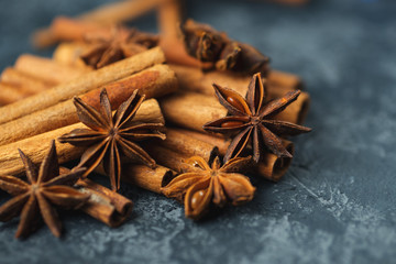 Cinnamon and anise group on a dark concrete background