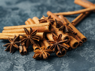 Cinnamon and anise group on a dark concrete background