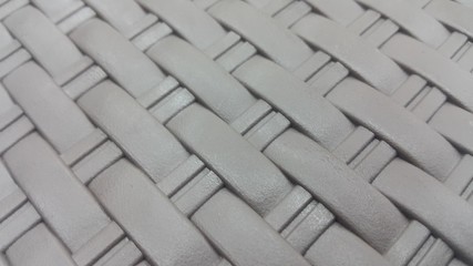Grey view of colorful plastic woven stripes.