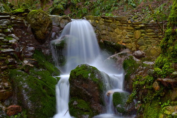 Naklejka na ściany i meble Incredible natural waterfall among the stones