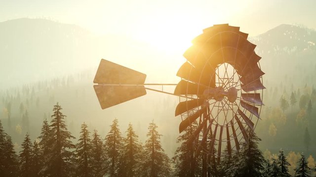 Typical Old Windmill turbine in forest at sunset