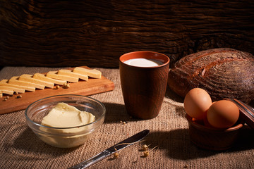Assorted dairy products milk, cheese, butter rustic still life on table