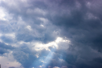  Close-up smiley wisping rays of sunlight through puffy clouds