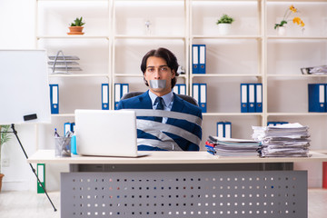 Young tied male employee in the office 
