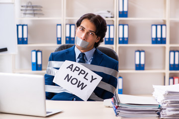 Young tied male employee in the office 