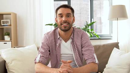 blogging, videoblog and people concept - male blogger recording video blog at home