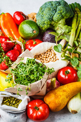 Balanced vegetarian food background. Vegetables, fruits, berries, nuts, sprouts, seeds, chickpeas on a white background.