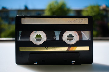 Old audio cassette 90s of production. Analog recording of music on magnetic media.