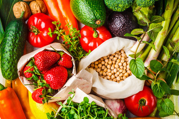 Balanced vegetarian food background. Vegetables, fruits, berries, nuts, sprouts, seeds, chickpeas on a white background.