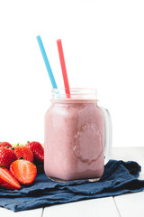 Smoothie with strawberry and banana in the jar isolated o white background