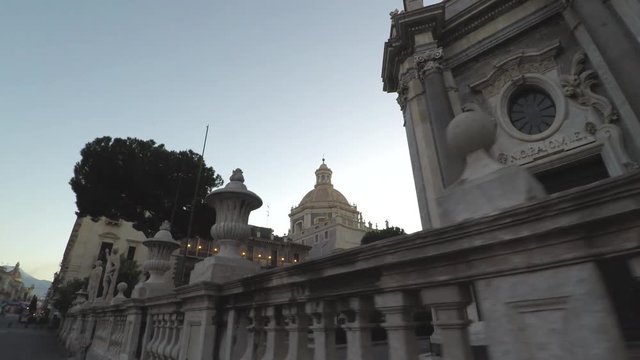 Catania baroque cathedral 4k moving view along the outside facade with statues in the dawn